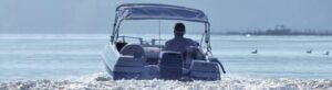 man driving boat on lake
