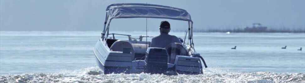 man driving boat on lake